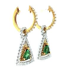 These earrings are gorgeous and stunning! Two trillion cut tsavorite garnets are set with round brilliant-cut diamonds and bright yellow sapphires. The garnets are a beautiful, brilliant grass-green color. The yellow sapphires and diamonds compliment and contrast with the green garnets and add even more sparkle. They are made of 18k white and yellow gold by our Master Jewelers in Los Angeles. Tsavorite garnets, 4.00 millimeters, .67 carat total118 round brilliant cut diamonds, .95 carat total36 Green Diamond Earrings In Fine Jewelry Style, Green Diamond Earrings Fine Jewelry, Green Diamond Earrings With Diamond Accents, Green Pave Setting Fine Earrings, Green Teardrop Diamond Earrings Fine Jewelry, Green Teardrop Diamond Earrings, Green Round Earrings With Pave Setting, Green Gemstone Diamond Earrings, Green Diamond Drop Earrings With Accents