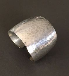 "This is a wide handcrafted Sterling Silver Hammered Solid Cuff Bracelet. Very special design is the perfect example of when simple can be bold. The cuff bracelet widest part: 2 1/16\" (5.2 cm);  Opening: 7/8\" Outside length:  6 1/2\" (16.51 cm) ;   Inner diameter: 2 1/8\"(5.40 cm);  Weight: 70 grams (2.25 troy oz) Please read description carefully. We have no return and exchange policy. Ask for help if you have any questions." Modern Handmade Cuff Bangle, Modern Handmade Cuff Bracelets, Modernist Handmade Cuff Bangle Bracelet, Handmade Adjustable Modernist Cuff Bracelet, Modernist Handmade Adjustable Cuff Bracelet, Contemporary Adjustable Cuff Bracelet, Modern Hammered Cuff Bangle, Modern Handmade Cuff Bracelet For Formal Occasions, Modern Handmade Cuff Bracelet For Formal Wear