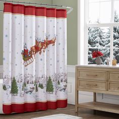 a christmas shower curtain with santa's sleigh flying over the snowy forest