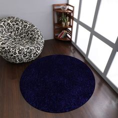 two round rugs on the floor in front of a window with open glass doors