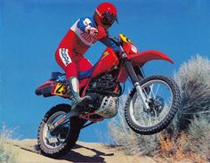 a man riding on the back of a dirt bike