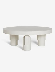 a white table with three pedestals on each side and one round in the middle