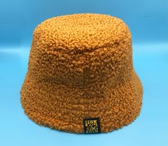 This is a listing for a handmade mustard yellow fluffy boucle bucket hat.  Attention has been paid to the quality and high standard of all make up details to this hat. It features a Stan&Gwyn label on the outside. For an added touch of comfort and breathability, the hat is lined in a plain cotton fabric and has a soft yellow corduroy inside brim. It's always best if you provide me with your exact head measurement for an accurate fit.  Otherwise please choose from the following sizes - Small - 22 Yellow Bucket Hat, Bucket Hat Winter, Fluffy Bucket Hat, Tweed Hat, Mens Bucket Hats, Ladies Accessories, Beautiful Mask, Soft Yellow, Bucket Hats