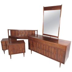 a wooden dresser and mirror with matching stools