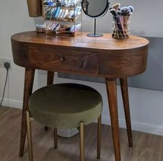 a wooden desk with a mirror and stool