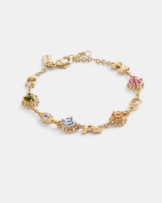 COACH® | Coach Stone Linear Bracelet Elegant Multicolor Metal Chain Bracelet, Coach Metal Bracelet Jewelry, Coach Formal Bracelet Jewelry, Coach Formal Bracelet, Coach Bracelets As Gift, Metal Bracelet With Sparkling Stones, Jeweled Cubic Zirconia Crystal Bracelet, Formal Adjustable Coach Bracelets, Gold-tone Bracelet With Clasp