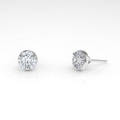 A diamond halo gives these classic, white diamond studs an extra sparkle. The Arcus collection highlights gemstone qualities through simple and clean designs, making these earrings appropriate for everyday wear. But the extra sparkle makes these Arcus Halo studs perfect for special occasions. Recycled metals White diamonds Approximately .2 total carat weight Handcrafted and made-to-order Halo Diamond Earrings As Gift, Diamond Halo Earrings As Gift, White Cluster Diamond Earrings With Halo Design, White Cluster Halo Diamond Earrings, Classic Diamond Cluster Earrings With Prong Setting, Fine Jewelry Diamond White Cluster Earrings With Halo Design, Cluster Diamond Earrings With Halo Design, Diamond White Cluster Earrings With Halo Design, Classic Diamond Cluster Earrings