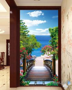 an open door leading to a scenic view of the ocean and trees with flowers on either side