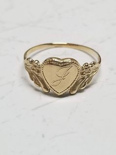 "Thanks for shopping our vintage estate store. We tend to sell well below wholesale and truly hope you enjoy all of our items. Many of the items are one of a kind, so please enjoy scrolling through the pictures and hopefully something will catch your eye. Brown spots are from camera or reflections. Estate 14k yellow gold monogram cursive capital J heart ring. Custom made ring for our shop. Ring size: 3 Setting: 7.5mm 1/4\" to 3/8\" Band width: 1.4mm Weight: .97 gram Marked 14k and it's sweet. On Vintage Gold Initial Ring Stamped 14k, Vintage 14k Stamped Initial Ring As Gift, Vintage Yellow Gold Engraved Initial Ring, Victorian Gold Initial Ring As Gift, Vintage Personalized 14k Gold Engraved Ring, Vintage Engraved Ring With Initials For Promise, Vintage Engraved Promise Ring With Initials, Vintage Engraved Initials Promise Ring, Victorian Yellow Gold Initial Ring For Anniversary