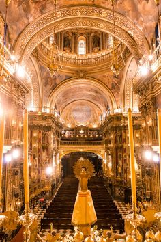 an elaborately decorated church with chandeliers and candles