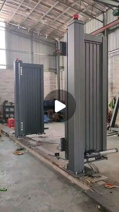 the inside of an industrial building with two large metal structures and one is being worked on