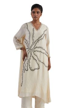 Off white kaftan hand embroidered with flower motif, asymmetric hem and sheer scalloped border detailing on neck and cuffs. Paired with a flared pant with sheer border on hem and contrasting line on sides. - Aza Fashions Spring V-neck Kaftan With Chikankari Embroidery, Elegant Floral Embroidered V-neck Kaftan, Elegant V-neck Kaftan With Embroidered Neckline, Elegant Kaftan With Chikankari Embroidery And V-neck, Elegant V-neck Kaftan With Chikankari Embroidery, White V-neck Embellished Kaftan, Asymmetric Pants, Kaftan Set, Hand Embroidered Flower