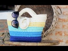 a crocheted bag with sunglasses on it