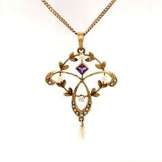 True Romance is an amazing, one-of-a-kind, turn of the 20th century, vintage necklace, featuring a delicate circular and trefoil pendant adorned with one old mine cut diamond, a square cut amethyst, and 17 seed pearls. This is truly a work of art and is stunning. The 10K yellow gold necklace is 18.5" with a spring ring closure. The total approximate weight including all materials is 3.10 dwt. Center Diamond: Old Mine Cut; Color Grade: F-G; Clarity Grade: SI1-SI2; Dimensions: 2.20mm; Total Carat Heirloom Necklace Vintage, Antique Pearl Necklace For Formal Occasions, Antique Wedding Necklaces With Jewels, Heirloom Pearl Pendant Necklace For Wedding, Antique Yellow Gold Necklaces With Jewels, Antique Yellow Gold Jeweled Necklaces, Vintage Rose Cut Diamond Pendant Necklaces, Victorian Pearl Necklace With Pearl Pendant, Vintage Pendant Necklace With Rose Cut Diamonds