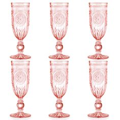 four pink glass goblets sitting next to each other on a white background,