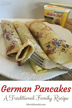 a white plate topped with pancakes covered in powdered sugar