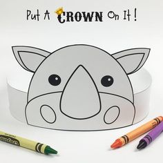 a paper crown with an elephant face on it and crayons next to it