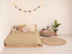 a bedroom with a bed, rugs and two teddy bears on the floor next to it