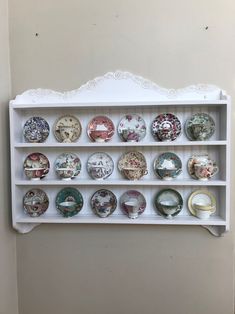 a white shelf filled with lots of plates