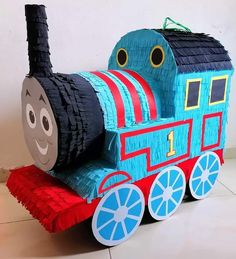 a train made out of paper sitting on top of a tile floor