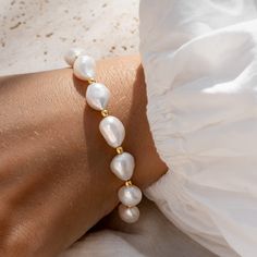 Our Pearl Bracelet (Ingrid) features baroque pearls studded with gold nuggets. This statement bracelet has adjustable length settings and can be worn at lengths between 6.5" and 8".

Baroque pearls measure at ~9.5 - 10mm. Beading Jewelery, Gold Nugget, Freshwater Pearl Bracelet, Handmade Jewelry Diy, Large Hoop Earrings, Sustainable Jewelry, Freshwater Cultured Pearls, Statement Bracelet, Hoop Earrings Small