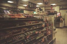 a grocery store filled with lots of food and vending machines in the aisles