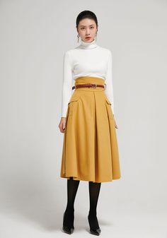 "The yellow wool skirt made with soft wool blend, it has a polyester lining inner. It is high waist skirt for winter day, The knee length skirt has two up-entry pockets. Back zipper made the skirt easy to wear. Details: * 30% wool, 30% fiber, 40% polyester * fully satiny liner * back zipper closure * two side pockets * High waisted pleated skirt * knee length effect * Dry clean CUSTOM MADE SERVICE If you * Need a tailored clothes with your body measurement * Need a Better fit * Can't find your s Pleated Skirts Knee Length, Long Wool Skirt, Skirt Winter, Tailored Clothes, Wool Winter Coat, Skirt Knee Length, High Waisted Pleated Skirt, Black Wool Coat, Knee Skirts