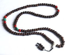 This is a Indian Bodhi Seed Mala with dark brown color Side cut.Its has been decorate with Naga shell and Red coral Beads. Handmade in Nepal. 11mm 108 beads 24inch long Necklace. Meditation Buddha Shop For Nepali handmade Products. We Supports Small Family Artisans who create a Beautiful handmade rituals Products. Bohemian Brown Mala For Rituals, Brown Bohemian Mala With 108 Beads, Bohemian Brown Mala With 108 Beads, Traditional Brown Mala For Meditation, Brown Bohemian Mala For Puja, Traditional Brown Mala For Rituals, Bohemian Brown Mala For Festivals, Brown Wooden Beads Spiritual Mala, Spiritual Brown Wooden Beads Mala