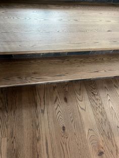 two wooden shelves sitting next to each other on top of a hard wood flooring