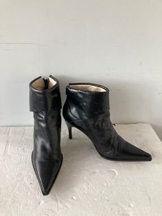 sz 8.5 length: 10.5 width:3.5'' height: 8.5'' insole: 9.5" heel height 3.5 vintage fashion 1990s black  leather boots ankle boots with a fold down cuff back zip high heel boot stack heel leather sole and lining a jeweled button on the side of the boots   high fashion BCBG MAXAZRIA label made in italy good condition Vintage Fashion 1990s, Fashion 1990s, High Heel Stiefel, Leather High Heel Boots, Ankle Boots Leather, Heel Boot, Favorite Boots, Black Leather Ankle Boots, Leather High Heels