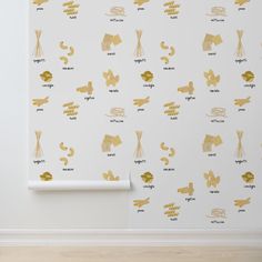 gold foiled wallpaper in an empty room with white walls and wood flooring