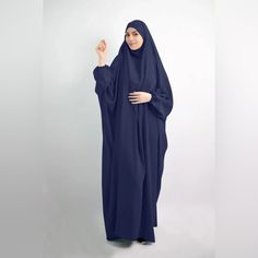 One Piece Khimar Abaya Dress Color: Navy Blue (To Buy Other Colors, Please See Separate Listings) One-Piece Ensemble: Seamlessly Combines Khimar And Abaya For A Complete, Modest Look. Tie-Back Feature For Flexible Adjustment Of Khimar. Chin Piece Can Also Be Brought To Use It As A Niqab Using Hijab Magnets Or Pins Elastic Balloon Sleeves: Ensures Comfort And Flexibility During Prayers. Length: 176cm From Head To Bottom, Gracefully Drapes For A Modest And Elegant Appearance And Is Loose Silhouett Blue Long Khimar For Eid, Long Blue Khimar For Eid, Blue Modest Long Abaya, Modest Long Sleeve Blue Kaftan, Modest Blue Dresses For Eid, Modest Blue Maxi Length Abaya, Casual Long Blue Abaya, Blue Long Sleeve Modest Khimar, Modest Long Blue Dresses