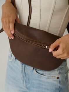 Meet the Atlas in Saddle Dark – now with more secret pockets and features to make staying organized on the go that much easier. Chase your next adventure and let this timeless leather fanny pack design carry you from plane ride to sunset and everywhere in between. Handmade by artisans in Bali, this roomy design is both elegant and versatile. For endless styling freedom, easily adjust the leather strap to wear as a bum bag, cross-body or over-the-shoulder. Leather Travel Belt Bag With Pockets, Leather Belt Bag With Pockets For Travel, Leather Belt Bag With Cell Phone Pocket For Travel, Travel Belt Bag With Pockets In Brown, Brown Travel Belt Bag With Pockets, Travel Brown Belt Bag With Belt Loops, Leather Belt Bag For Travel, Brown Belt Bag With Pockets For Travel, Modern Leather Belt Bag With Pockets