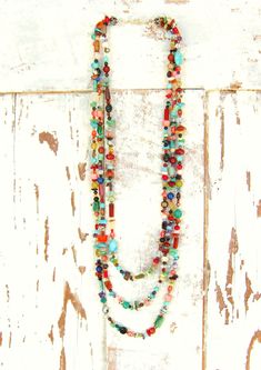 "Three pretty graduated strands of multi color, semi precious stones make up this long bold necklace. Just about every stone you can imagine, turquoise, garnet, lapis, pearls, chrysoprase, red coral, and carnelian, just to name a few. The stones are accented with Bali sterling silver fancy spacers. The necklace measures 33\" in total length. The longest strand measures 33\" the middle strand measures 30\" and the shortest strand measures 27\". All three strands are connected with a sterling silv Cheap Multicolor Strand Necklace, Luxury Multicolor Beaded Necklaces With Natural Stones, Luxury Long Necklace With Colorful Beads, Cheap Multicolor Strand Jewelry, Luxury Multi-strand Colorful Beaded Necklaces, Luxury Multi-strand Necklace With Faceted Beads, Luxury Multicolor Carnelian Beaded Necklaces, Cheap Southwestern Multicolor Necklaces, Silver Heart Jewelry