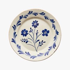 a blue and white plate with flowers on it