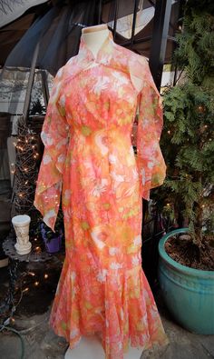 "Vtg 1960's Orange Pink Green Floral Grecian Style Full Length Nylon Dress & Scarf sz S/6 This is a lovely vintage dress I picked up recently in New England. It's a bright sheer nylon fabric in orange, pink, and green. It is a Grecian off the shoulder style. This dress is fully lined. The bottom of the dress has beautiful triangular inserts. There is a back zipper here as well. I believe this dress is hand made and it is nicely done. There is a beautiful scarf that goes along with the dress Vintage Orange Floral Print Dress, Retro Orange Dress For Garden Party, Orange Retro Dress For Garden Party, Vintage Orange Dress For Garden Party, Spring Party Dress With Vintage Print, Spring Mid-century Dresses For Vintage Events, 1970s Style Dresses For Vintage Events In Spring, 1970s Style Spring Dresses For Vintage Events, Retro Vintage Dress For Spring Events