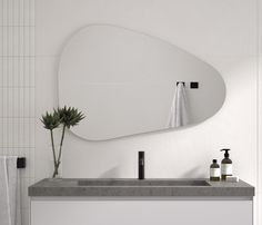 a bathroom with a sink, mirror and soap dispenser