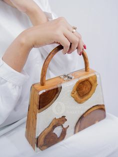 Nusantara Cari Handmade Wooden Teakwood Handbag, Top Handle Bag with Epoxy Resin, Women Fashion Handbag, Women Gift Materials: Teak Wood, Epoxy Resin, Premium Gail for Inner 📐Dimensions: Length: 24 cm / 9.4" Width: 6.5 cm / 2.6" Height: 25 cm / 9.8" 👜 Unique Design: One pattern for each handbag. The item received will have a different pattern from the picture since it's a natural wood. ✨ These wooden bags are made by hand, which means more attention to detail and higher quality items.  ✨ Eco-f Wood Bags Handmade, Beige Box Bag With Top Carry Handle As Gift, Beige Box Bag With Top Handle As Gift, Beige Box Bag With Top Carry Handle For Gift, Beige Box Bag With Top Carry Handle, Brown Rectangular Box Bag For Gifts, Rectangular Bags With Bamboo Handle For Gift, Rectangular Bag With Bamboo Handle As Gift, Rectangular Bag With Bamboo Handle For Gift