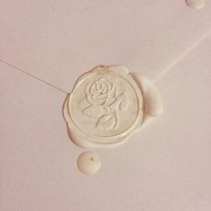 a wax stamp with a rose on it