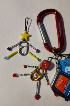 several different types of key chains on a white surface with one red, one blue and one yellow