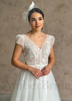 a woman in a wedding dress with a veil on her head