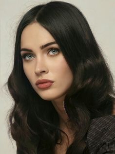 a woman with long black hair and blue eyes is posing for the camera while wearing a suit