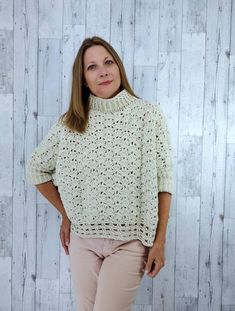 WELCOME TO BLUEEYEDSTYLE! This is a unique and stylish cream colored cowl neck crochet poncho sweater made for those cool fall and winter days when you just need something light but cozy! This oversized sweater has beautiful stitch definition. It also has a short cowl neck and a unique chunky knit design for the bottom trim. It is made with a washable, soft and stretchy Polyester yarn that has a pretty, light gold sparkle running throughout the garment. This would fit best sizes xs- medium/lg, a Cozy Cream Crochet Sweater, Oversized Open Knit Crochet Top For Fall, Oversized Open Knit Poncho For Fall, Beige Crochet Poncho For Fall, Fall Crochet Beige Poncho, Oversized Crochet Poncho For Winter, Winter Open Knit Poncho, Winter Cream Crochet Tops, Winter Crochet Cream Tops