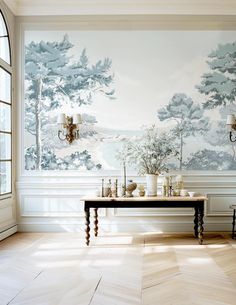 a room that has a table in the middle of it and wallpaper on the walls