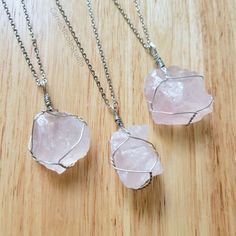 "These lovely chunky crystal pendants are handmade with beautiful pink raw rose quartz stones wrapped with silver jewelry wire and paired with your choice of 2mm silver-plated chain, 2mm stainless steel chain, or an 18-inch long black waxed cotton cord necklace. Each rose quartz crystal is unique, with varying saturation and size. ~Pendant Size~ The pendants vary in size, measuring around 1.5 to 1.75 inches long, and they are around 0.75 to 1.25 inches wide. (The measuring tape in the pictures i Cotton Cord Necklace, Aqua Aura Quartz, Handmade Crystal Jewelry, Crystal Statement Necklace, Raw Rose Quartz, Quartz Crystal Pendant, Wire Tree, Wire Wrapping Crystals, Rose Quartz Necklace