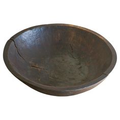 an old wooden bowl is shown on a white background with no one around it to see