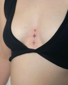 a woman's chest with three stars on it