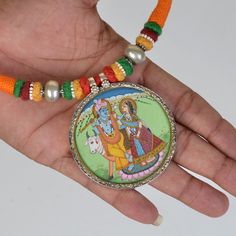 Weight- 28.5 Grams Approx 2 In 1 Pendant Necklace Double side Silver Hand Painting Pendant Necklace One side God Ganesha Painting & back side God Radha Krishna Painting Hindu Indian Necklace Handmade Pendant 92.5 Silver one side Ganesha Pendant Miniature Painting and second side Hindu God Radha Krishna Hand Painting, Glass Framed Pendant With Silver Lock Primary Color of Pendant is Silver. Necklace Thread Colour- Red Orange and Green beautiful combination of colour. Weight of Necklace- Approx 80 Gram Covered by silver and glass. Used natural water colours on paper sheet. It's a totally handmade hand Painted Miniature Painting Hindu Deity Pendant from Rajasthan. Artistic Multicolor Jewelry For Wedding, Artistic Multicolor Wedding Jewelry, Multicolor Necklaces For Puja, Multicolor Necklace With Oxidized Finish For Gift, Festival Locket Necklace, Hand Painted Amulet Necklace With Round Pendant, Traditional Necklace With Artistic Design For Festivals, Traditional Necklaces With Artistic Design For Festivals, Handmade Temple Necklace With Round Pendant For Festivals