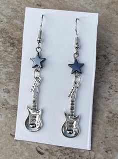 Silver guitar charm dangly earrings ~2.5 inches from the top of the earring hook to the bottom of the guitar DM me if you have any questions or concerns! :) Guitar Earrings, Punk Rockstar, Silver Guitar, Earring Hook, Dangly Earrings, Rock Star, Punk Rock, Dublin, Jewelry Ideas