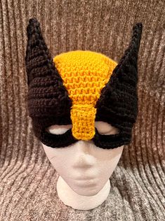 a crocheted hat with horns on top of a mannequin's head